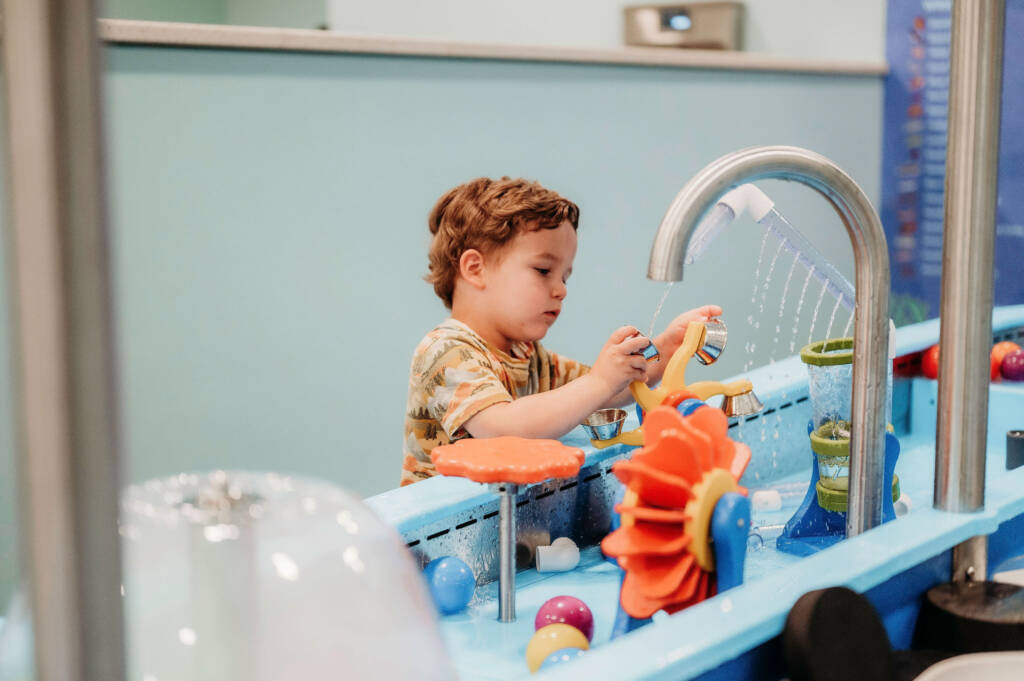 Child playing at the water table